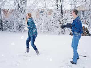 Couple having a snow ball fight